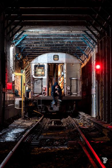 Silhouette of a man taking a cigarette on a train ready to be scrapped