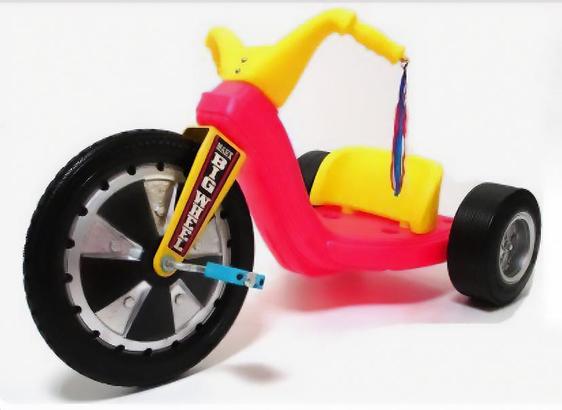 Image of a 1970's red and yellow Big Wheel plastic tricycle. 