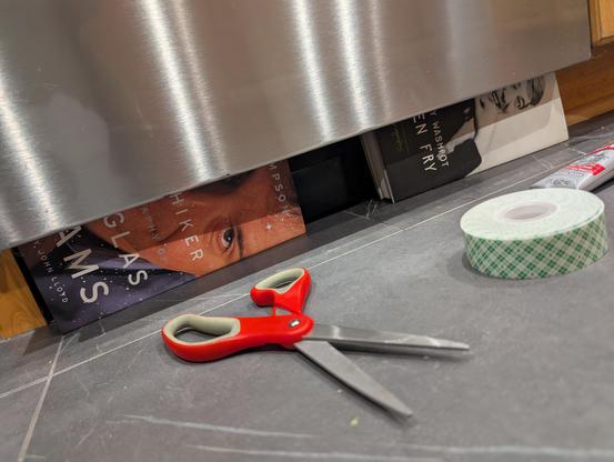 Pic of a dish-washer with two books visible underneath.