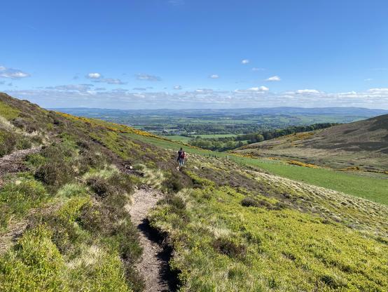 Hikers up on a hill overlooking a valley