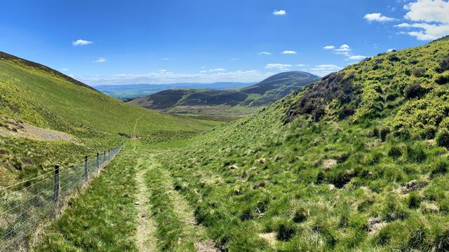 Empty hiking trail between gentle curves of the Pentland Hills
