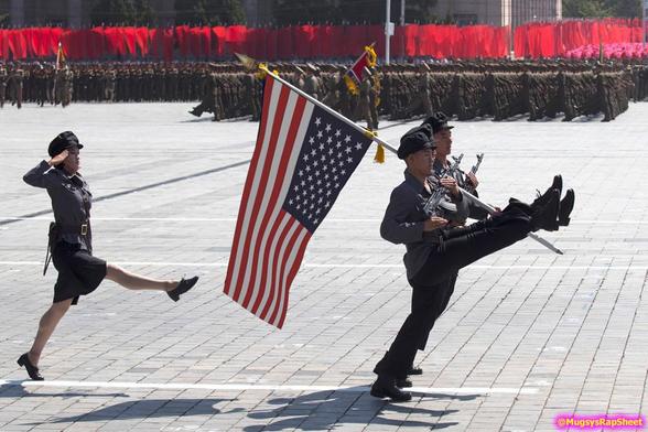 Goose-stepping soldiers marching with an upside down American flag.