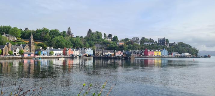 The waterfront at Tobermory, as viewed from across the bay, from two churches on the left of the image to the ferry terminal on the right. Many of the buildings are painted pretty colours so it looks rather cheerful, even on not the brightest day.