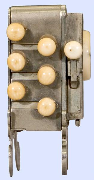 Side view of the Symphonium. Metal box with seven ivory or bone small round buttons.