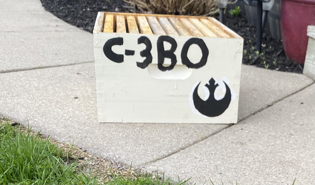 Beekeeping deep box with C-3B0 & rebel sign painted on side
