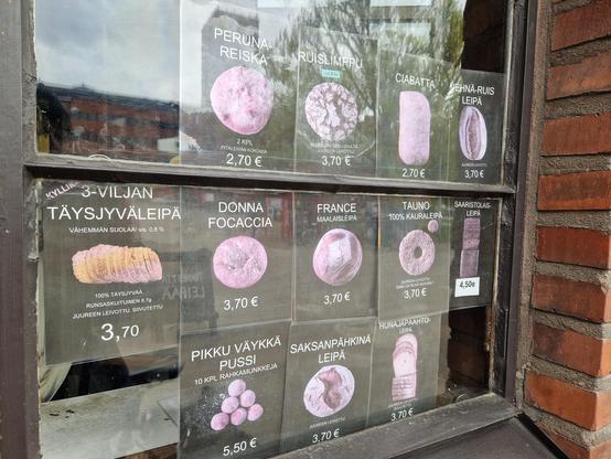 Bakery menu in their window showing the different loaves on offer.