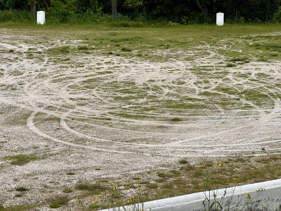 Trails of cars in circles in the sand