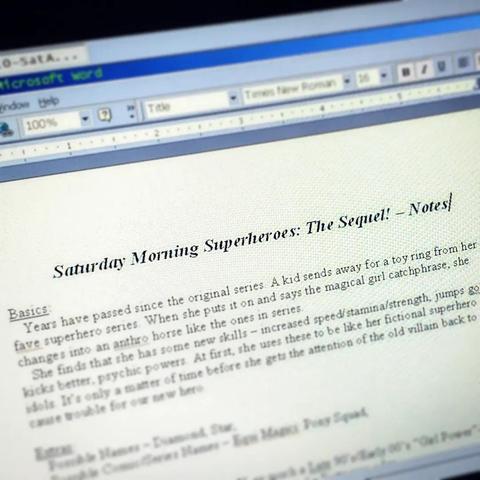 Photo of my Netbook. On screen is an open Word 2K window with a file all set up. A title reads "Saturday Morning Superheroes: The Sequel! - Notes". There's extra text that boils down to it being a series set years after the original Saturday Morning Superheroes story with a girl who changes into a superpowered horse girl instead of a cereal mascot bunny like the previous kid. The rest is blurred. 