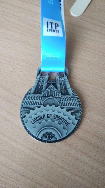 Lincoln GP Sportive medal, showing the cathedral behind some cogs