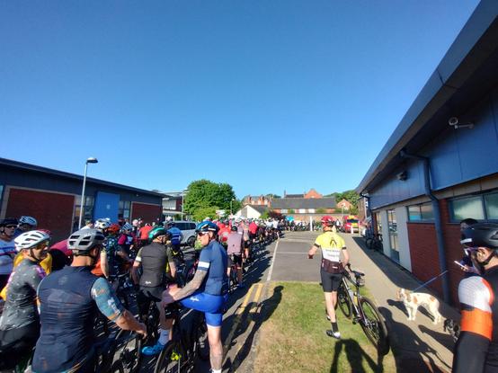 The queue for the starting line - LOTS of cyclists beneath a clear blue sky.