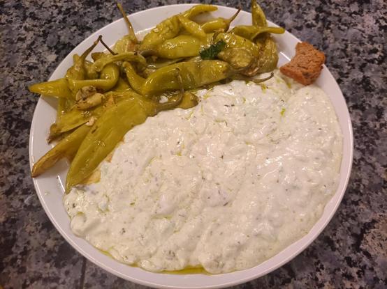 fried peppers in olive oil with lots of garlic and a huge blob of tsatsiki
