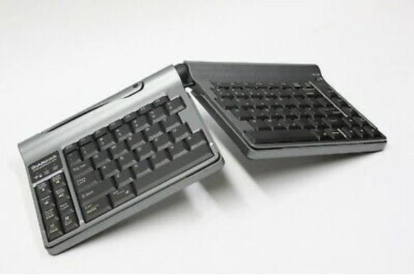 Old Goldtouch portable semi-split keyboard. Joined by a ball-joint at the peak near the 6-7 keys. The locking joint allows it to be moved and tented at any position and angle up to 30° as long as the boards don’t get too far apart. 