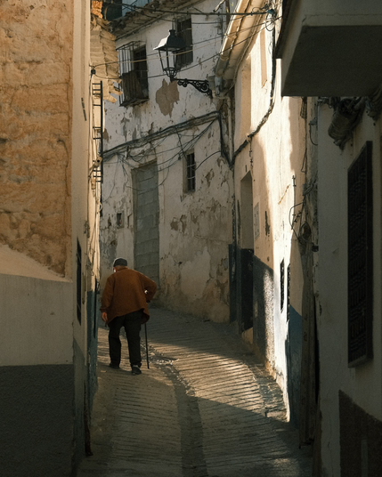 A senior person is walking up a hill