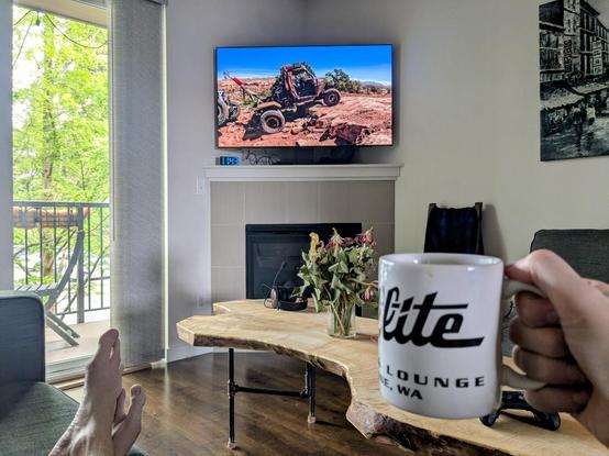 Trailmater on a large TV, coffee mug from the Satellite Diner in Spokane in the foreground.