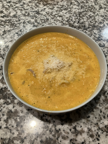 Picture of yellow soup with Calamari (squid)