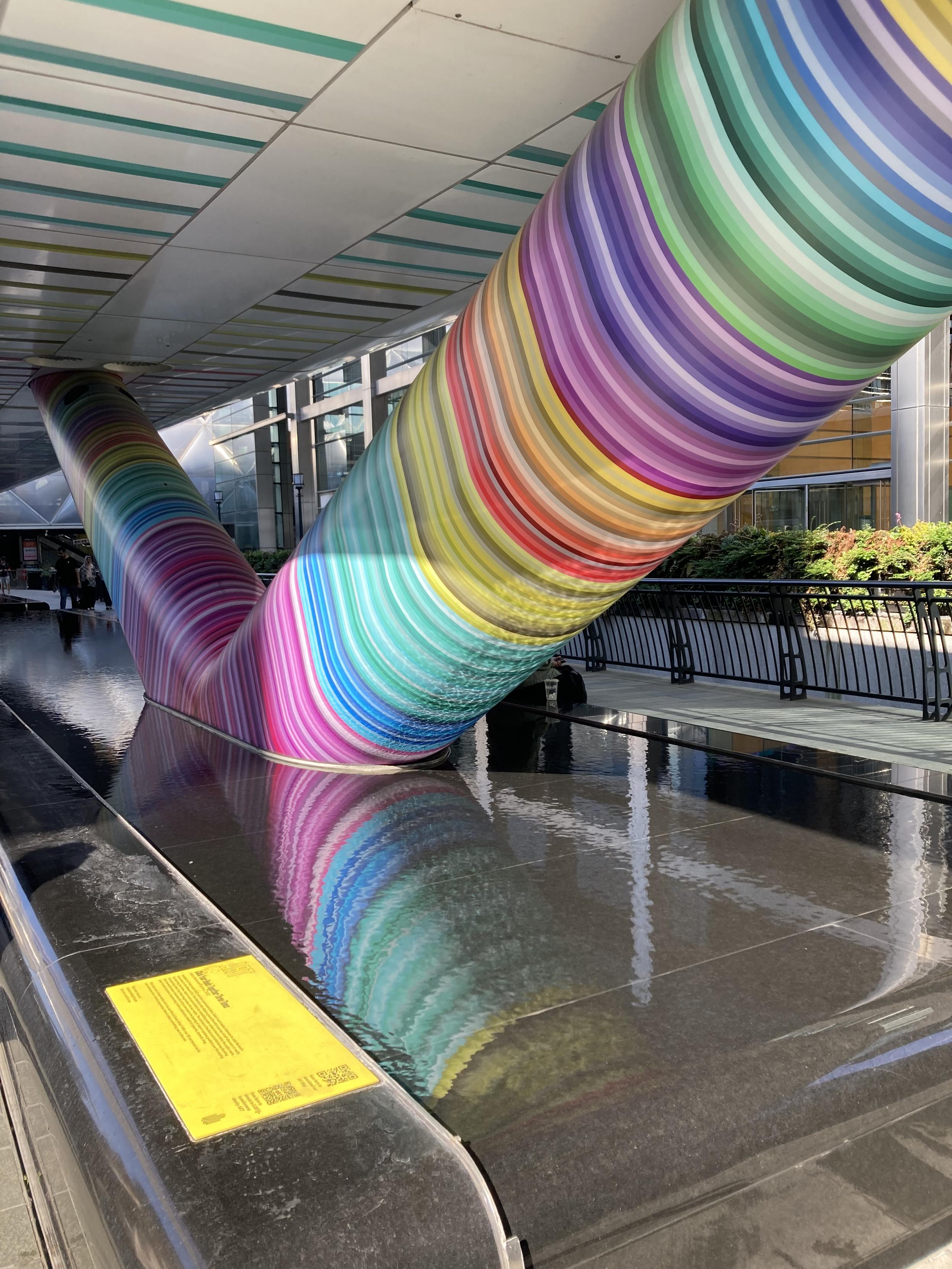 one of the supports underneath the bridge at Adam's Place, decorated in colourful pride stripes