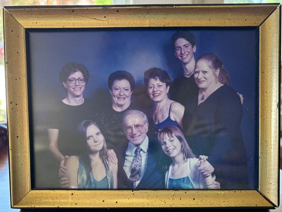 Family photo from a bat mitzvah showing three generations. Three adults stand behind three children—two girls and a boy—all dressed up and smiling. Now, only I and the kids remain. Everyone else in the photo is gone.
