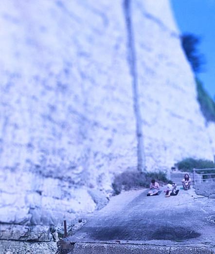 .. three young amigos sit upon a concrete outcrop of the Ramsgate Undercliffe walkway .. the summer scene is altered by filters giving the scene a ghostly purple haze .. while white cliff tower above the contented fellows .. either "ominously", or as a "shelter" .. you can guess ..