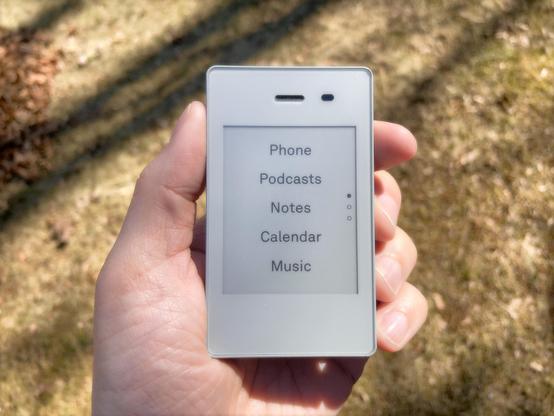 A photo of a smartphone with an e-ink display. 