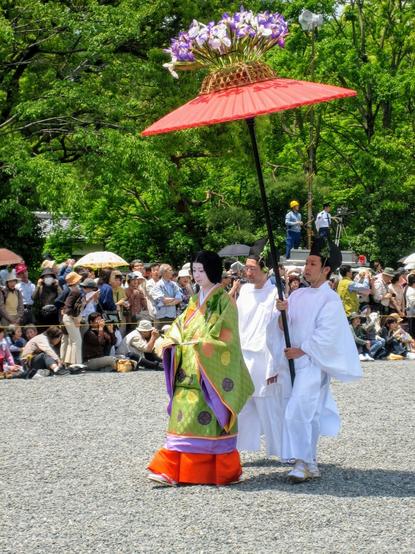 Large parasols decorated with irises shade the lady courtiers during the parade (the multi-layered kimonos worn are particularly heavy and taxing in the hot May weather).