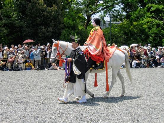A lady-in-waiting is led on horseback during the Aoi Matsuri parade.