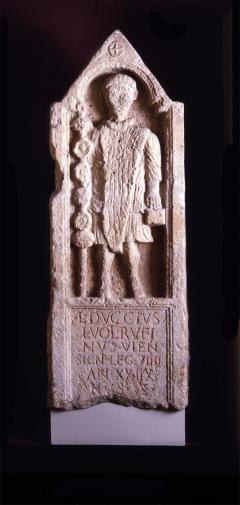 The tombstone with a standing soldier with a standard