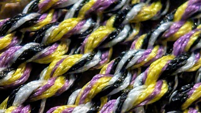 Purple, yellow, white, and black yo-yo string