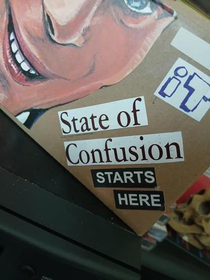 An art piece that says state of confusion starts here
