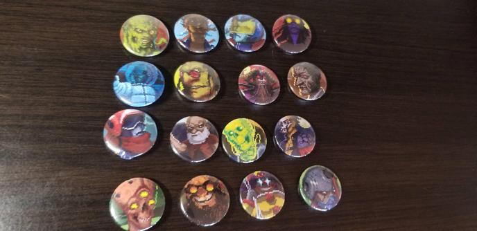 16 buttons depicting various drivers from the video game Highway Rampage lined up in a row 