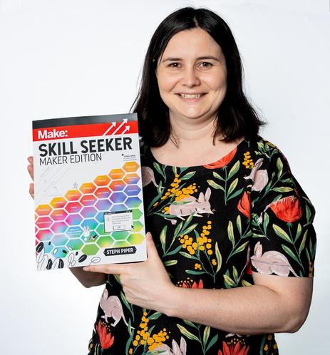 Steph Piper, the author, holding her book, Skill Seeker: Maker Edition.  