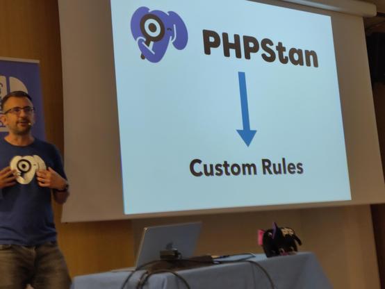 Dave in front of a slide with an arrow pointing from "PHPStan" to "custom rules"