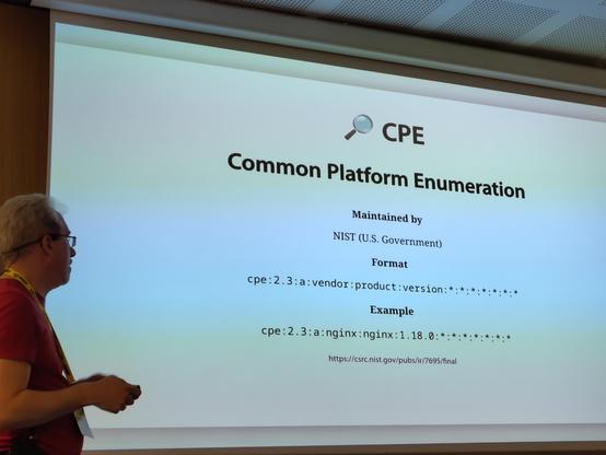 Arne in front of a projector slide with examples of a CPE (Common Platform Enumeration) identifier by NIST