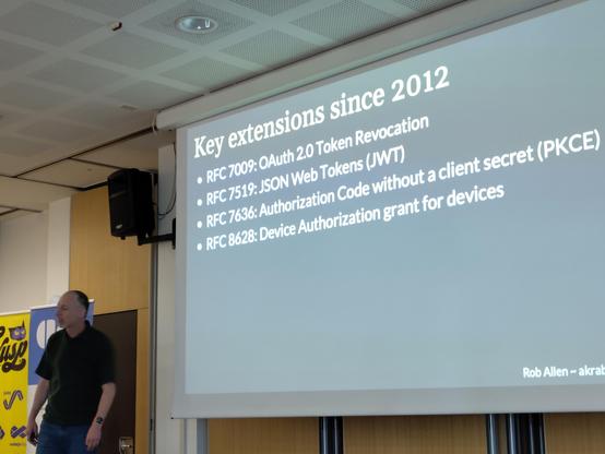 Rob Allen standing in front of a projector slide listing the most important OAuth improvements since 2.0