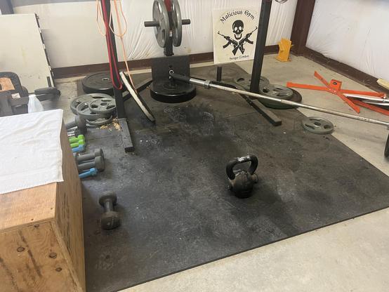 Wooden box, dumbbells, and a kettle bell on rubber flooring