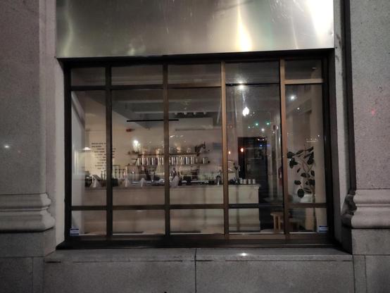 Photo taken from a downtown Tacoma sidewalk late on a May evening. It's a window looking into a tea shop hours after closing for the night. 