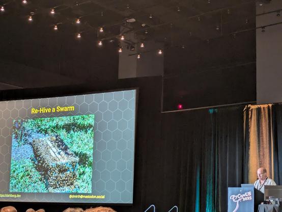 Slide showing "Re-Hive a Swarm" and a picture of bees around a crate