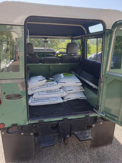 A series 2a Land Rover showing 250kg of builder's sand in the back