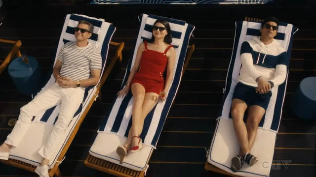 Max, Avery and Tristan are lying on sun loungers text to each other at the pool of the Odyssey.