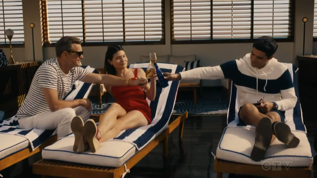 Max, Avery and Tristan sit on their sun loungers at the pool of the Odyssey and clink their glasses in a Happy Ending kind of way for the show. Max and Avery have each a glass of champagne. Tristan has a beer bottle.
