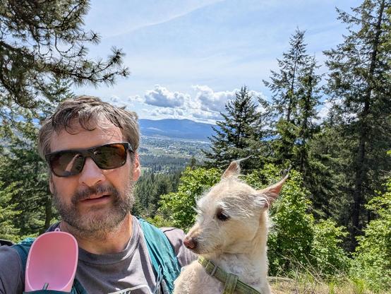 our go-to shot just passed the Canfield golds trail junction. looking out over the valley today. we have a Momo and me with a selfie. looking back you can see the Momo water thinger in my vest. I am wearing sunglasses and looking very scruffy like very very scruffy. Momo has a sideways look inquiring what we are doing and if we are heading back. it's a lovely day. still cool but with the warm sun.