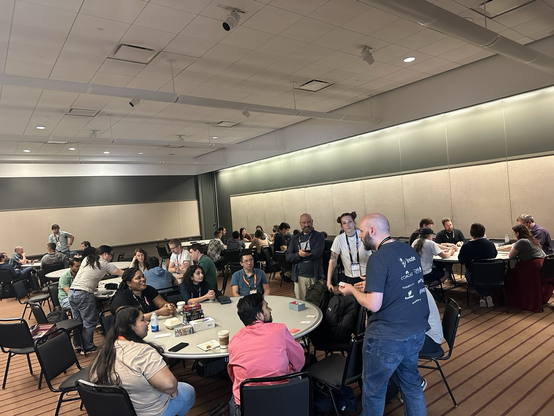 PyCon attendees playing board games in a room at PyCon US 2025!