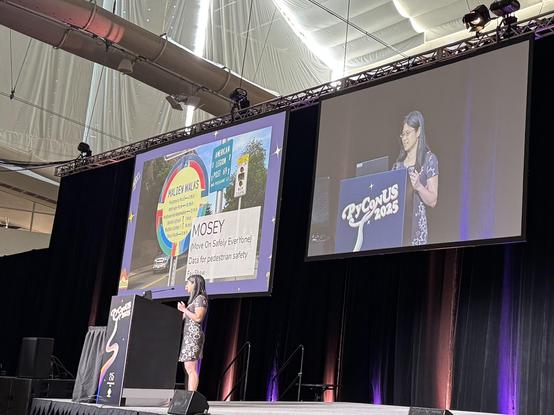 Fay on stage at PyCon US giving a talk about data and walkability.