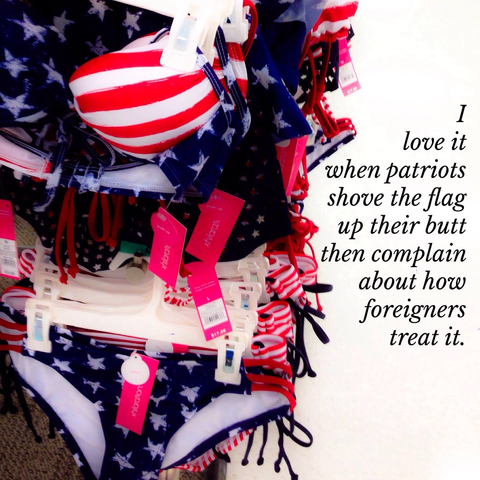 A rack of bikini bathing suits for sale patterned as though made of the US flag. The text says: I love it when patriots shove the flag up their butt then complain about how foreigners treat it. 