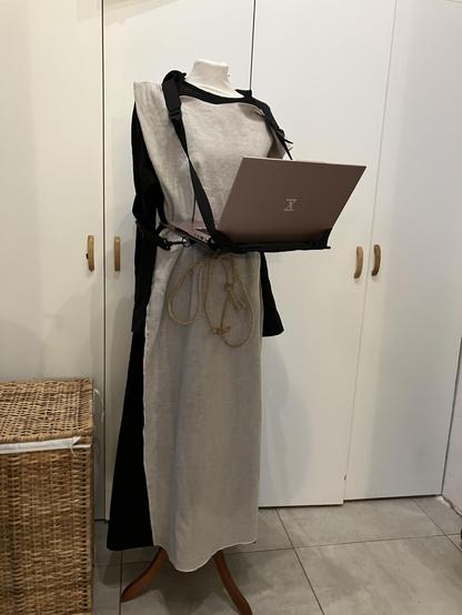 black linen robe, natural linen tabard with tuxedo computers pink laptop strapped to a female mannequin