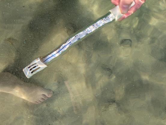 A submerged thermometer shows 13°C