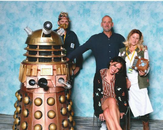 My dalek, Derek, stands proudly with Christopher Ecclestone, Billie Piper, my wife, and me, at the Emerald City Comicon photo op. My wife is dressed as Billie Piper's character "The Moment" from the 50th anniversary special.
