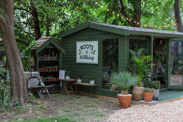 The Roots of Wellbeing houseplant studio in dark grey with lots of pots