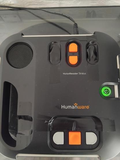 The front of a VictorReader Stratus with the modified shield installed.
Only six buttons are visible.
Play/Pause, Rewind, Fast Forward, Volume Up, Volume Down and the Power button.

(That's six more than was hidden by the standard shield.)