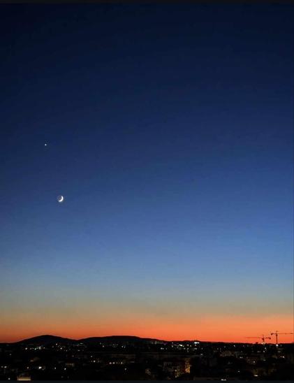 A beautiful sky at the end of the day with the moon, along with a lonely planet