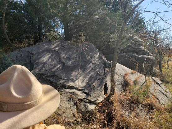 Ranger Sarah view a few rocks hiding in the trees. The geological oddity has drawn a variety of people, including Native Americans, mountain men, soldiers, and present-day tourists.
— at Mushroom Rock State Park.
